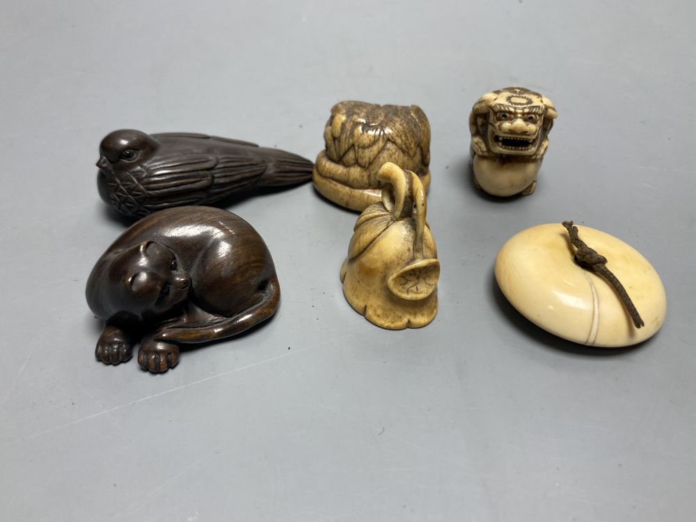 Two Japanese staghorn netsuke of lion dogs, two ivory netsuke of a lotus pod and a manju, 19th century and two modern wood netsuke